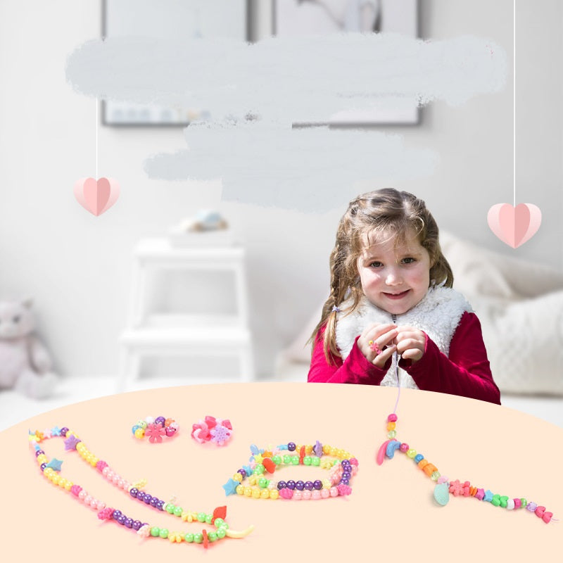 Child threading beads onto cord from the bracelet making kit