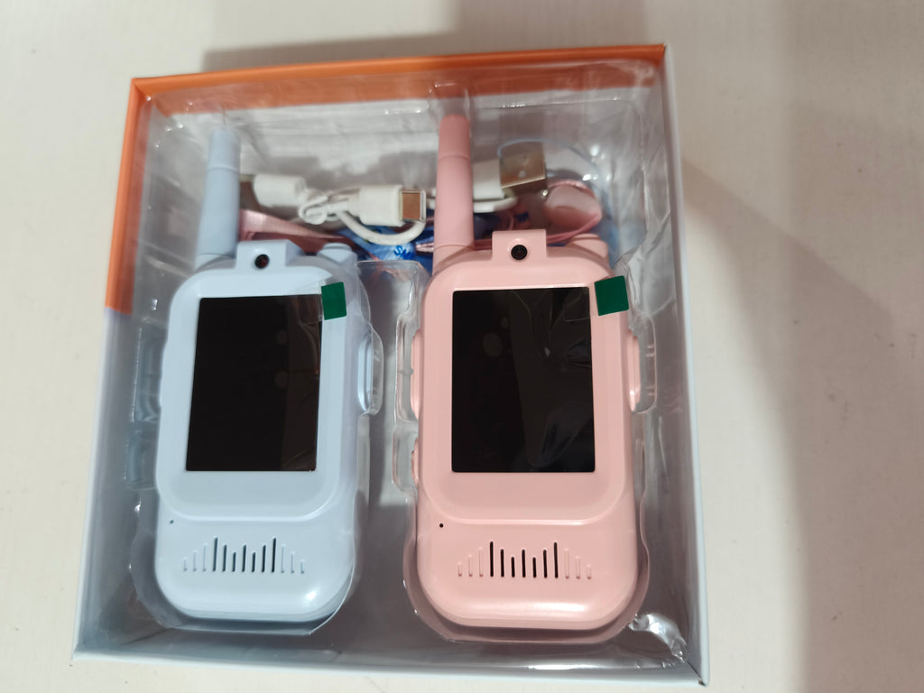 Two children using KidsStrike video walkie talkies outdoors