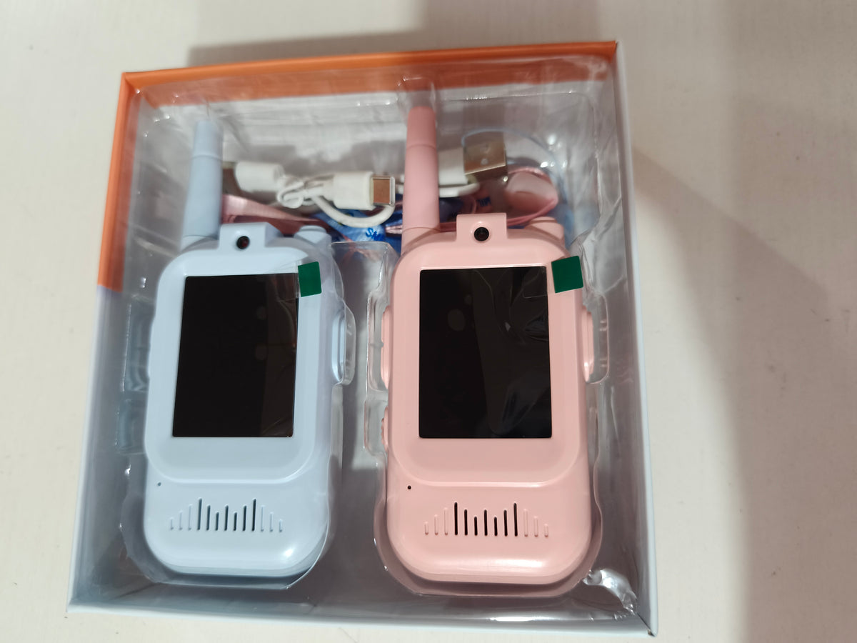 Two children using KidsStrike video walkie talkies outdoors
